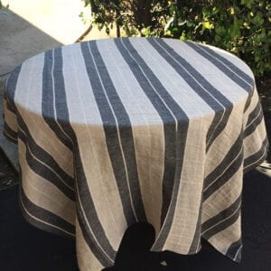 A linen table cloth with broad black and white stripes