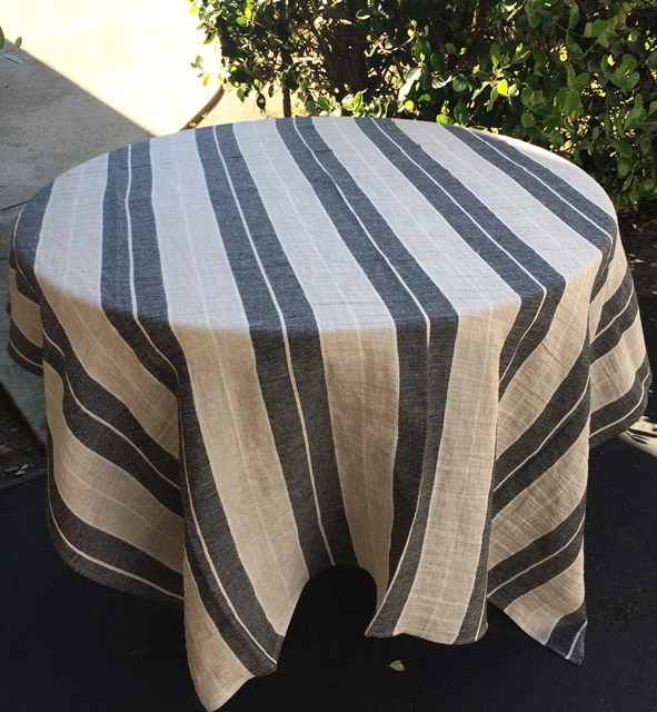 A linen table cloth with broad black and white stripes