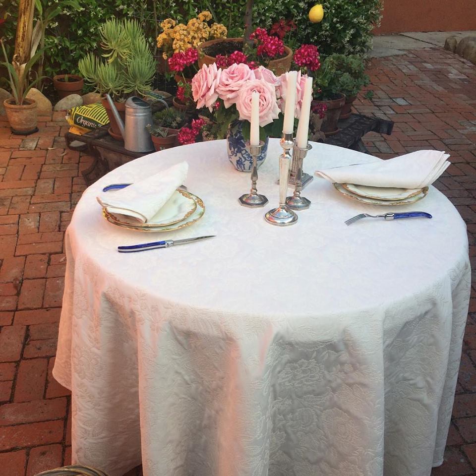 A table with elegant tableware and a flower arrangement