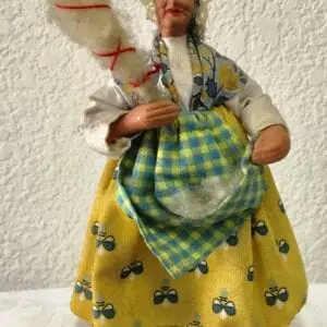 A small statue of an old woman with a duster