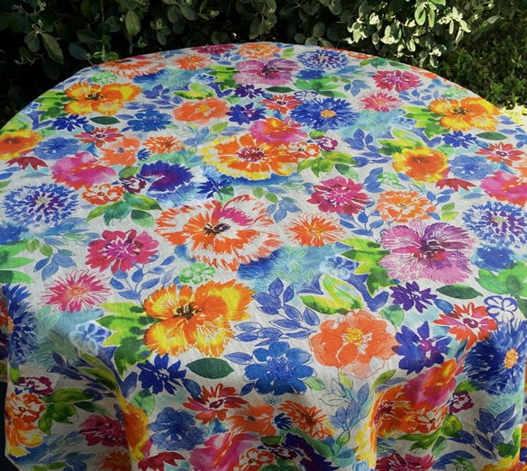 A linen table cloth with colorful flower designs
