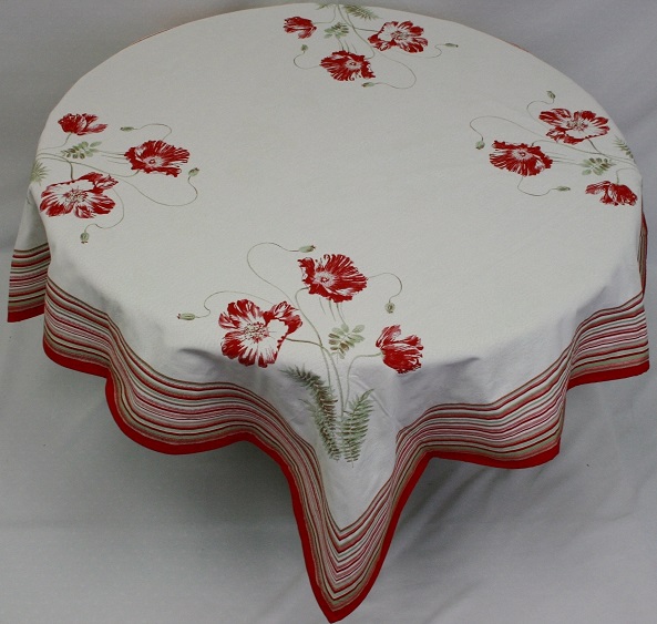 A white table cloth with four red flower patterns