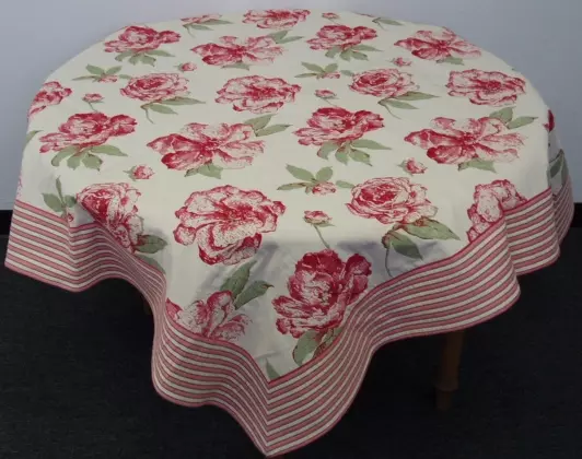 A white table cloth with pink flower designs