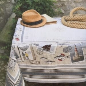 A white table cloth with a hat and rope on top