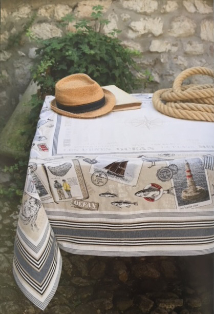 A white table cloth with a hat and rope on top