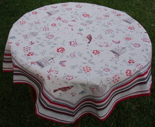 A white table cloth with red floral designs
