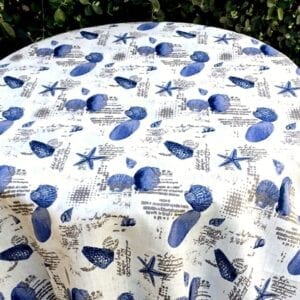 A white cloth with blue shells as patterns