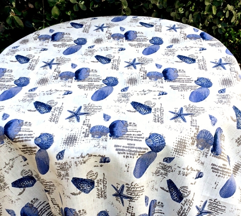 A white cloth with blue shells as patterns