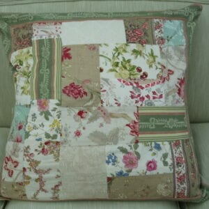A small pastel pillow with floral designs