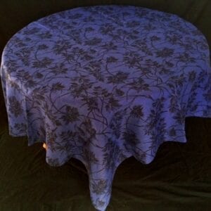 A linen table cloth with floral and plant patterns