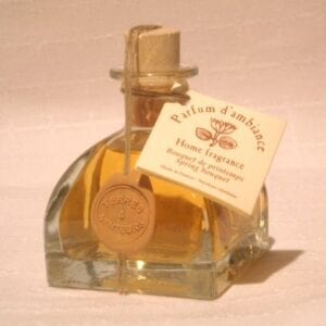 A bottle of yellow perfume with spring bouqet scent