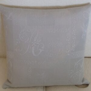 A grey pillow case with pale white designs