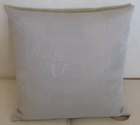 A grey pillow case with pale white designs