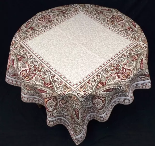 A white table cloth with red patterns around the edges