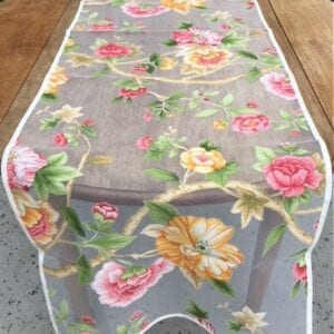 A cloth with yellow and pink floral designs on a table