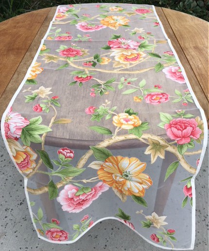A cloth with yellow and pink floral designs on a table
