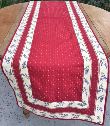 A red with floral designs on a table with white borders