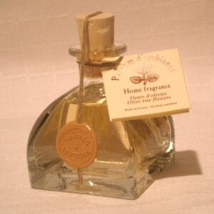 A bottle of yellow perfume with olive tree flowers scent