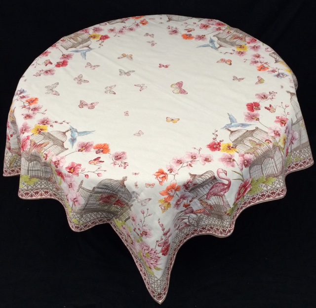 A white table cloth with butterfly and flower patterns