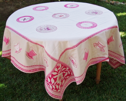 A white table cloth with pink designs