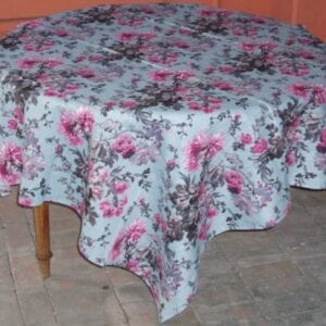 A linen table cloth with pink floral designs