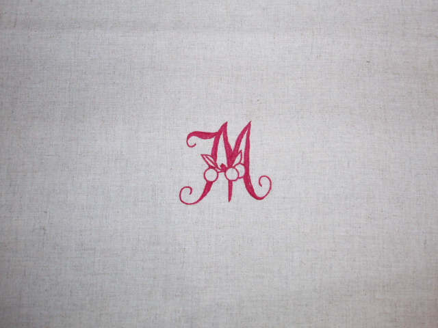 An elegant pink M embroided in the fabric
