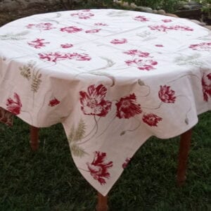 A white table cloth with red flowers