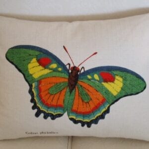 A white pillow case with a colorful butterfly