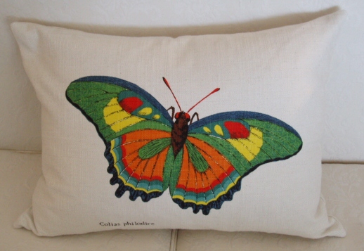 A white pillow case with a colorful butterfly