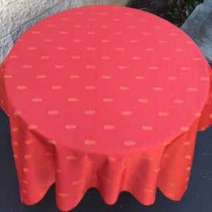 A pale red table cloth with bright patterns