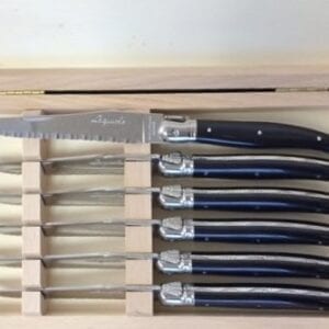 Knives with black handles in a box