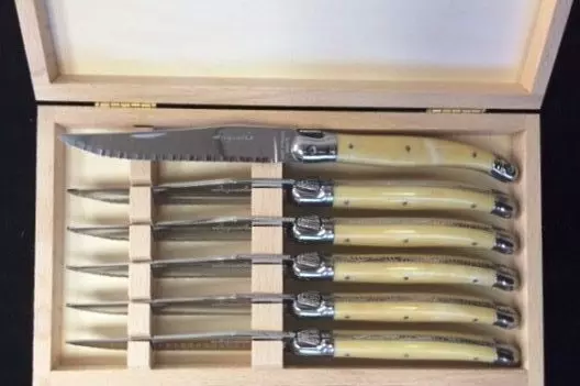Knives with cream handles in a box