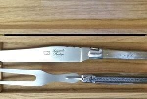 Two metal utensils with wooden handles