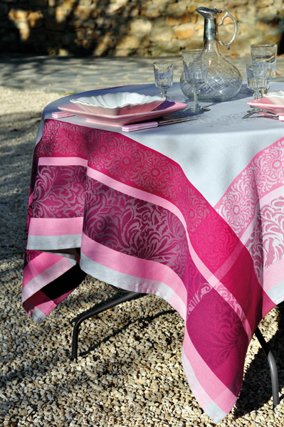A white table cloth with pink patterns