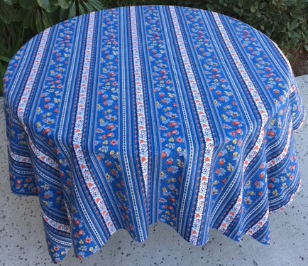 A blue table cloth with patterns and white stripes