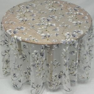 A grey table cloth with silver petals and flowers