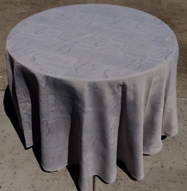 A grey table cloth with dark patterns