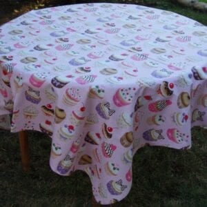A white table cloth with cupcake patterns