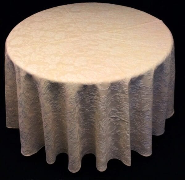 A cream colored table cloth with patterns