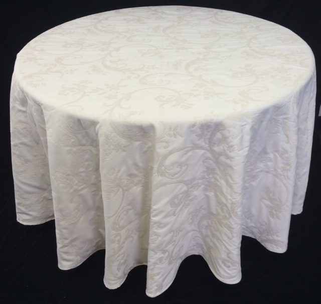A white table cloth with darker patterns