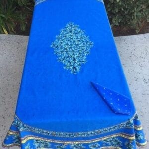 A rich blue table cloth with flowers in the center