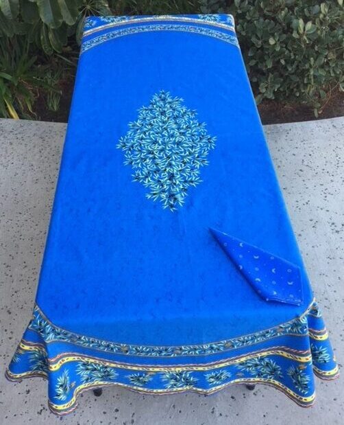 A rich blue table cloth with flowers in the center