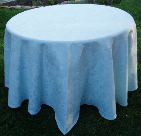 A light blue table cloth with dark patterns