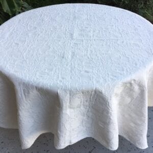 A white table cloth with rough patterns
