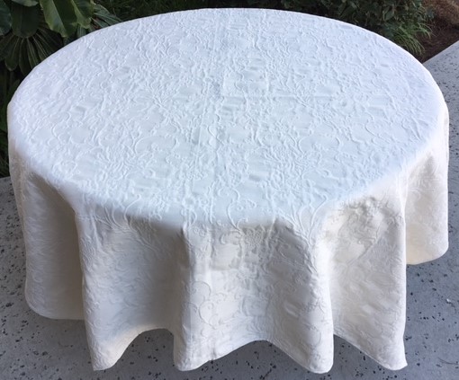 A white table cloth with rough patterns