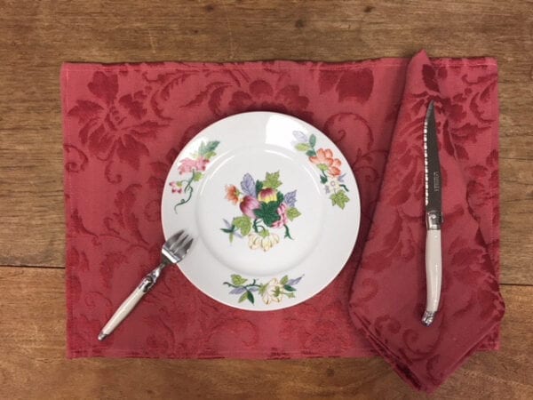 A red placemat with a dish