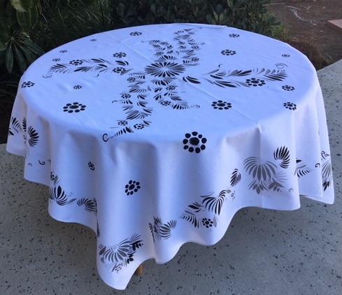 A white table cloth with black patterns