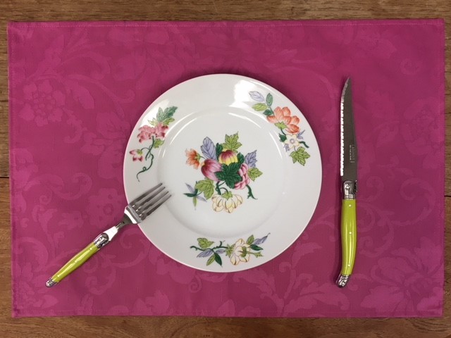A purple placemat with a plate