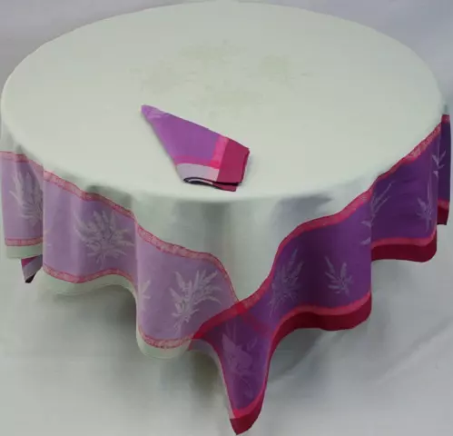 A white table cloth with pink and purple patterns