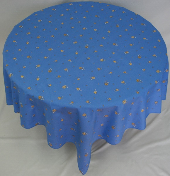 A blue table cloth with small yellow flower patterns
